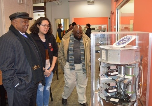 Prof. Mutisya and Dr. Endege during tour at WPI look at an object that has been used in space.